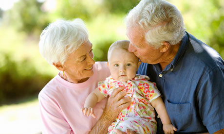 Grandparents holding a baby